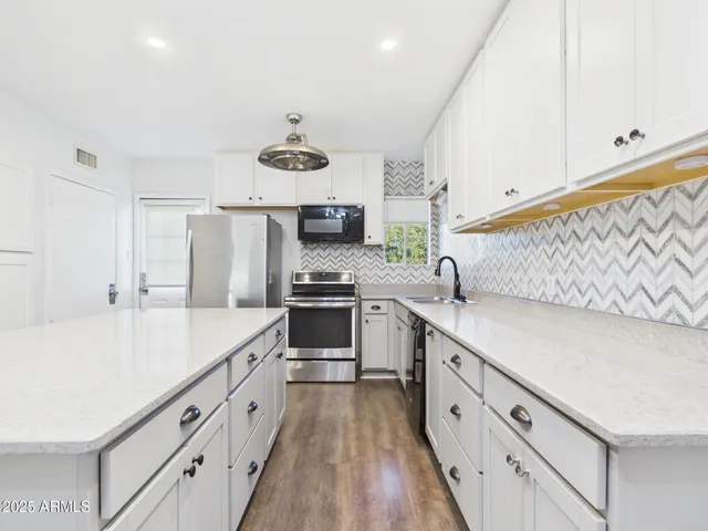 a kitchen with cabinets a sink and appliances