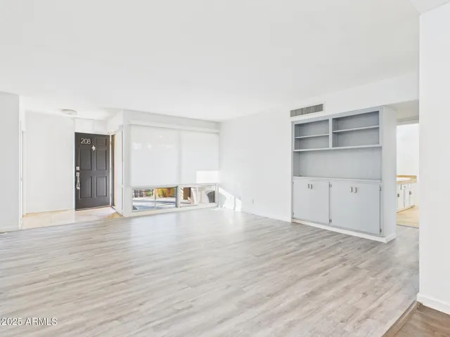 a view of empty room with wooden floor