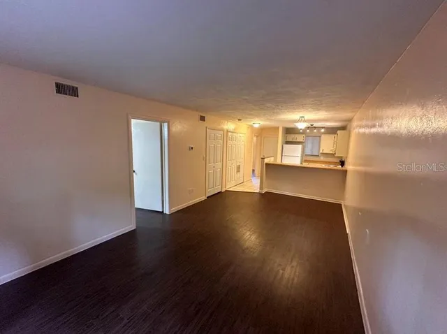 a view of a kitchen with wooden floor and a kitchen