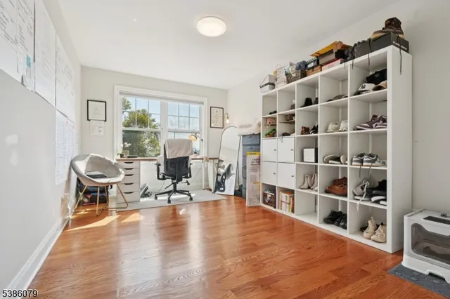 a living room with furniture cabinets and a book shelf