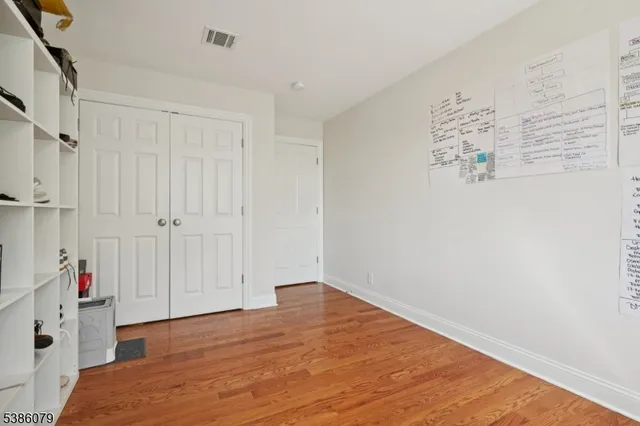 a view of hallway with wooden floor