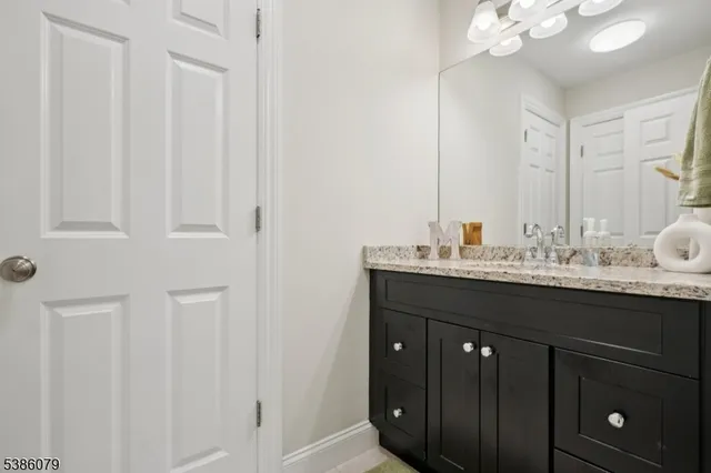 a bathroom with a sink vanity and a mirror