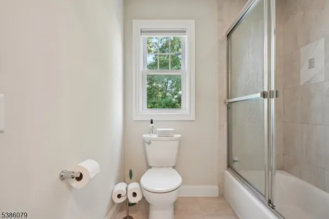 a white toilet sitting next to a bathroom sink
