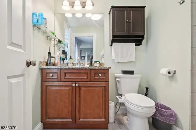 a bathroom with a sink a toilet and mirror
