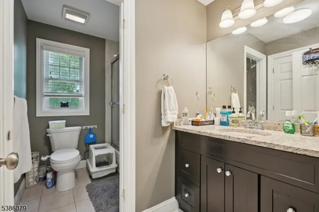a view of bathroom with a sink and a mirror