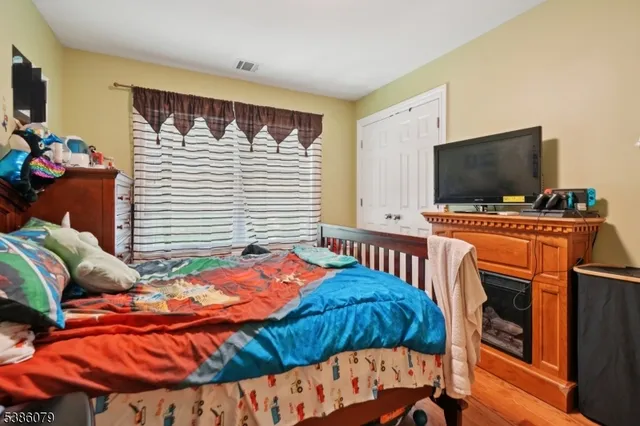 a bedroom with a bed and flat screen tv