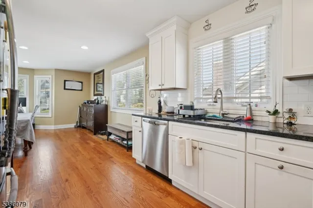 a kitchen with sink cabinets and wooden floor