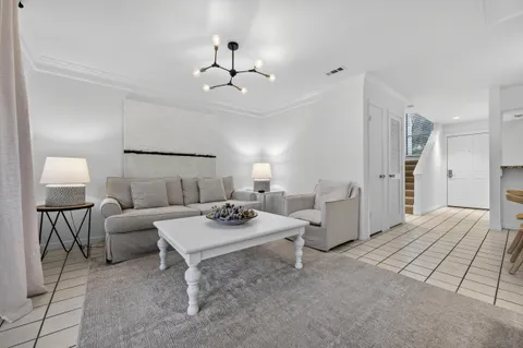 a living room with furniture and a lamp