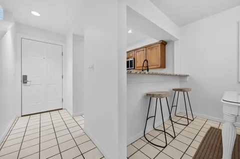 a living room with furniture a flat screen tv and a floor to ceiling window
