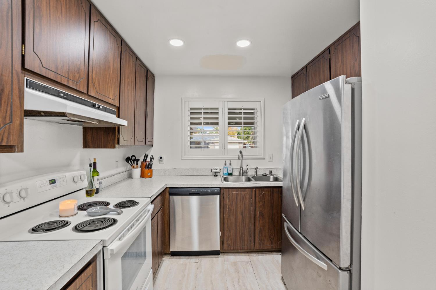 3412 Huntsman Drive Sacramento, CA 95826 - Photo 15 of 32 a kitchen with stainless steel appliances granite countertop a sink stove and refrigerator