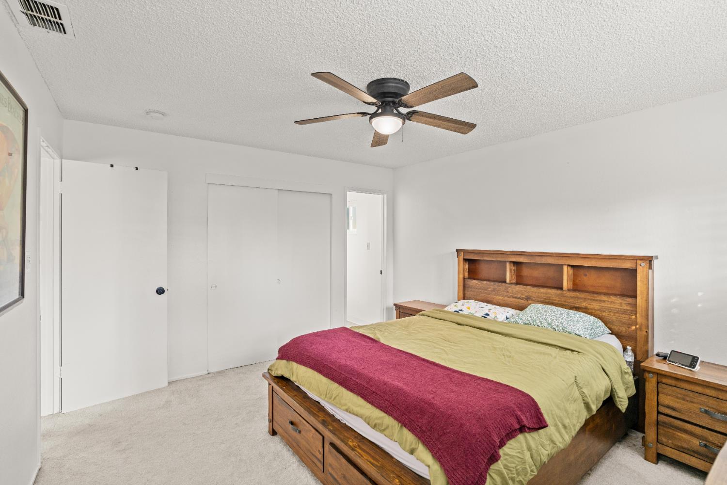 3412 Huntsman Drive Sacramento, CA 95826 - Photo 19 of 32 a bedroom with a bed and a chandelier