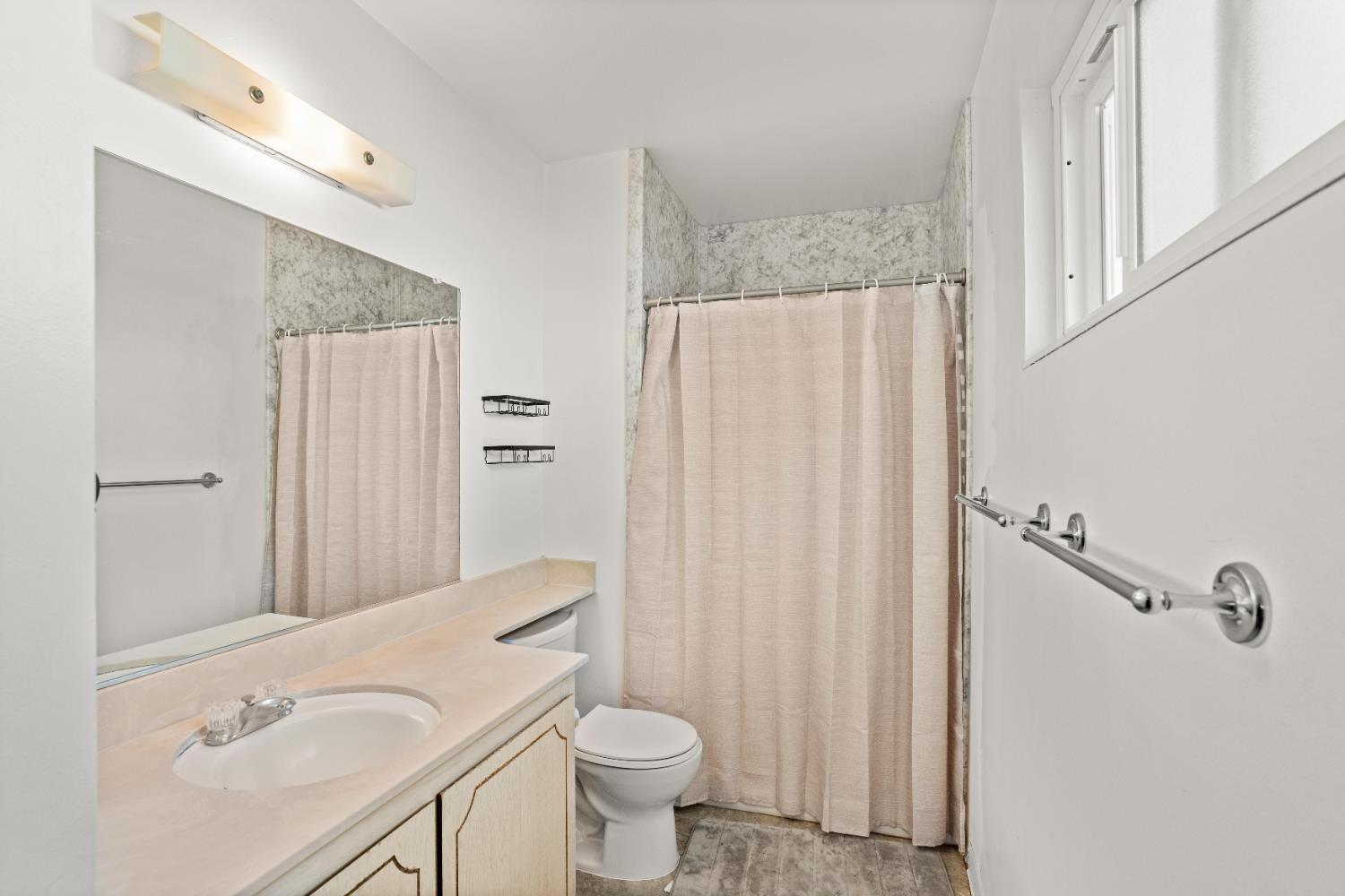 3412 Huntsman Drive Sacramento, CA 95826 - Photo 21 of 32 a bathroom with a sink a toilet a mirror and shower