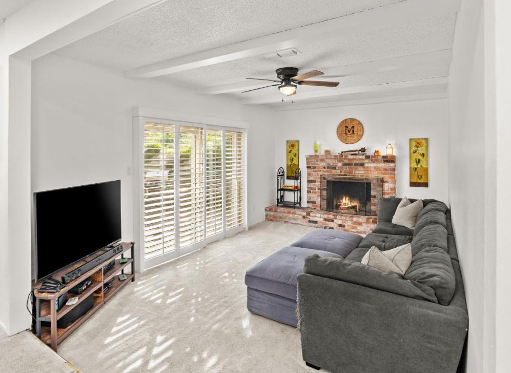 3412 Huntsman Drive Sacramento, CA 95826 - Photo 9 of 32 a living room with furniture a flat screen tv and a fireplace