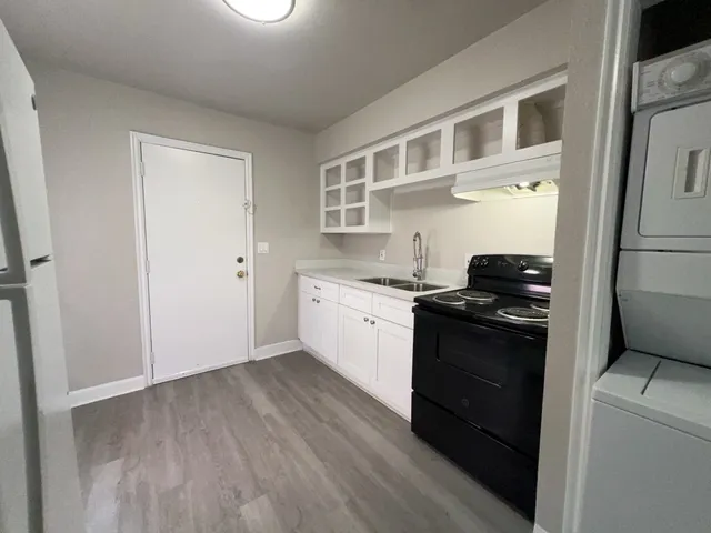 a white kitchen with a stove top oven