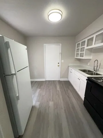 a kitchen with a refrigerator and a sink