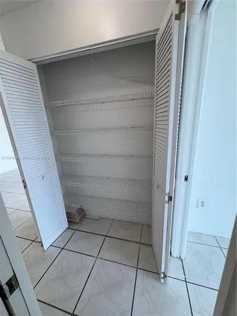 a view of a livingroom with an empty space and a window