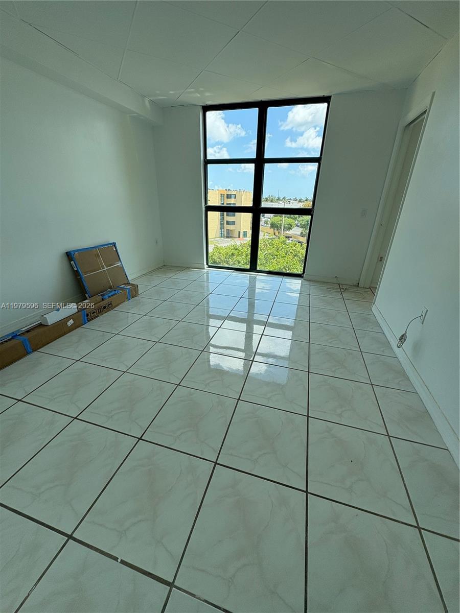 11800 Southwest 18th Street, Unit 5174 Miami, FL 33175 - Photo 13 of 22 a view of a livingroom with an empty space and a window