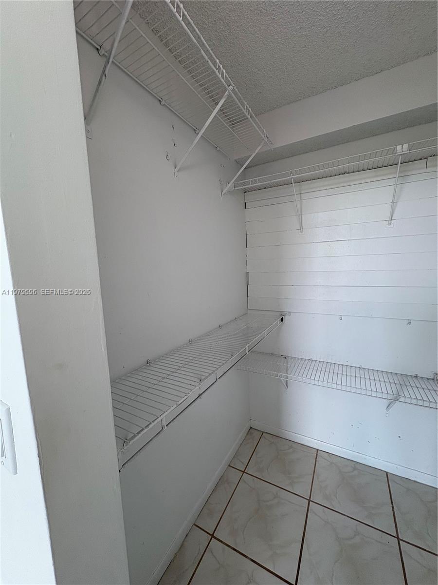 11800 Southwest 18th Street, Unit 5174 Miami, FL 33175 - Photo 18 of 22 a view of a room with racks on the wall