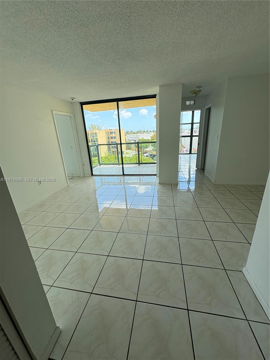 11800 Southwest 18th Street, Unit 5174 Miami, FL 33175 - Photo 2 of 22 a view of an empty room with glass door