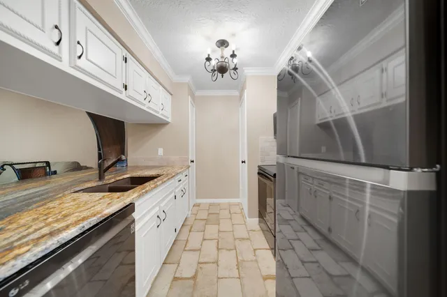 a bathroom with a granite countertop sink a vanity and window