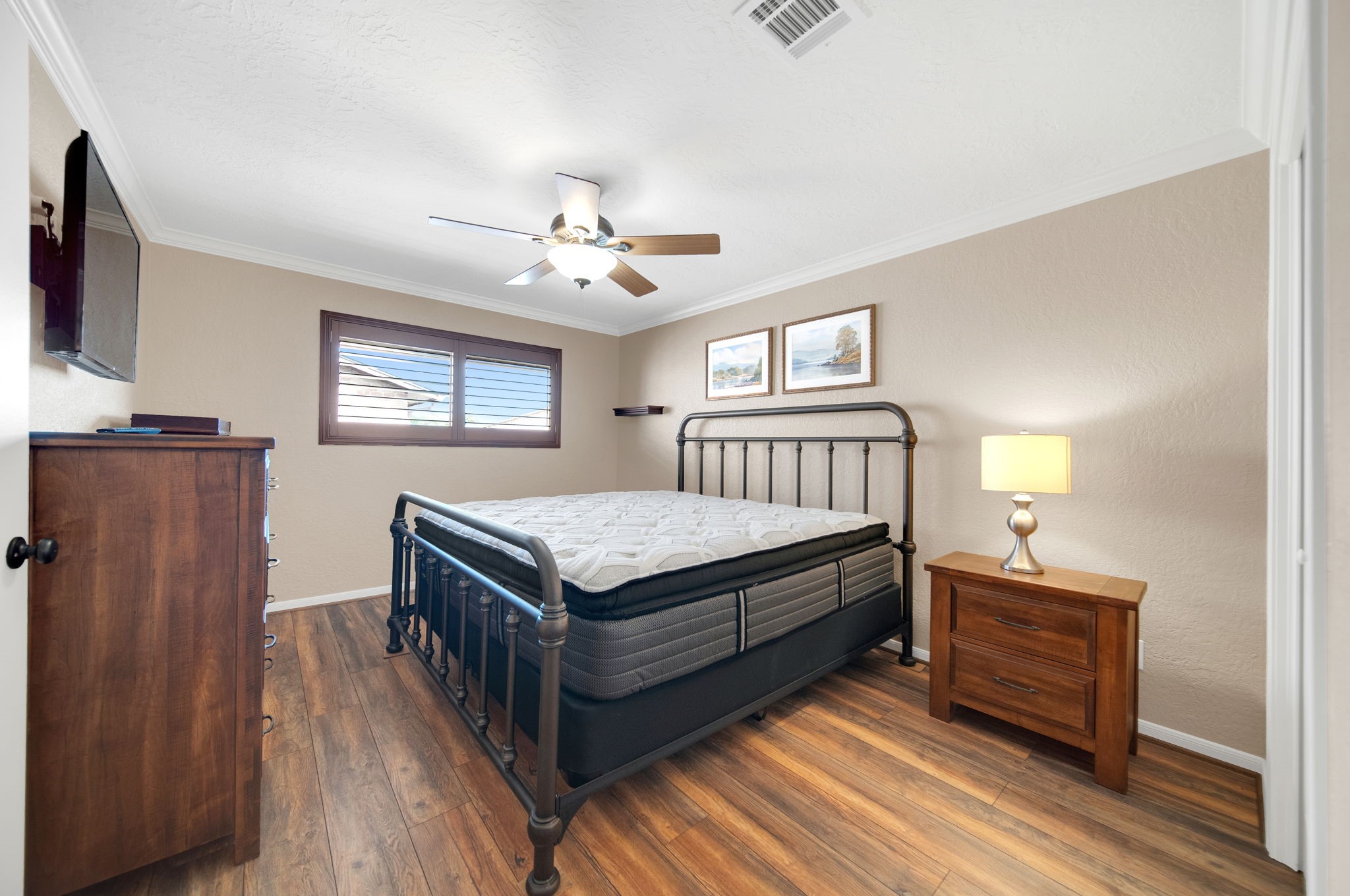 801 River Road, Unit E 116 Montgomery, TX 77356 - Photo 8 of 14 a bedroom with a bed and wooden floor