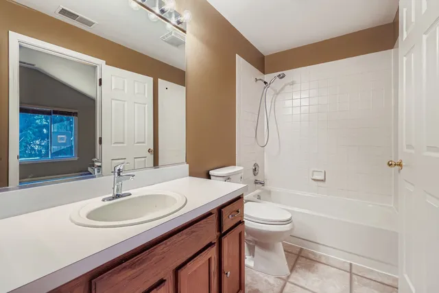 a bathroom with a sink toilet a mirror and shower