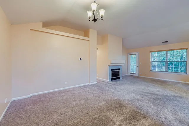 a view of empty room with a fireplace