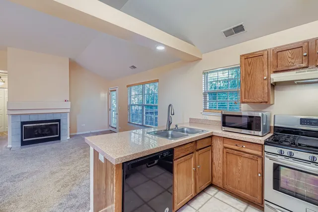 a kitchen with a sink stove and oven