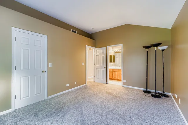 an empty room with closet and a table