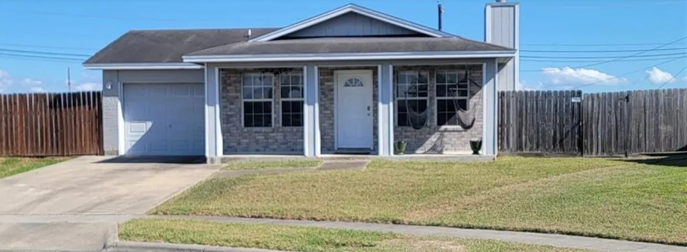 a front view of a house with a garden