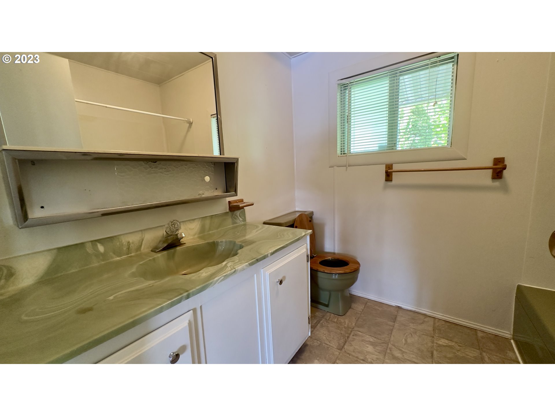 1695 Harbor Drive Springfield, OR 97477 - Photo 14 of 26 a bathroom with a sink a vanity and mirror