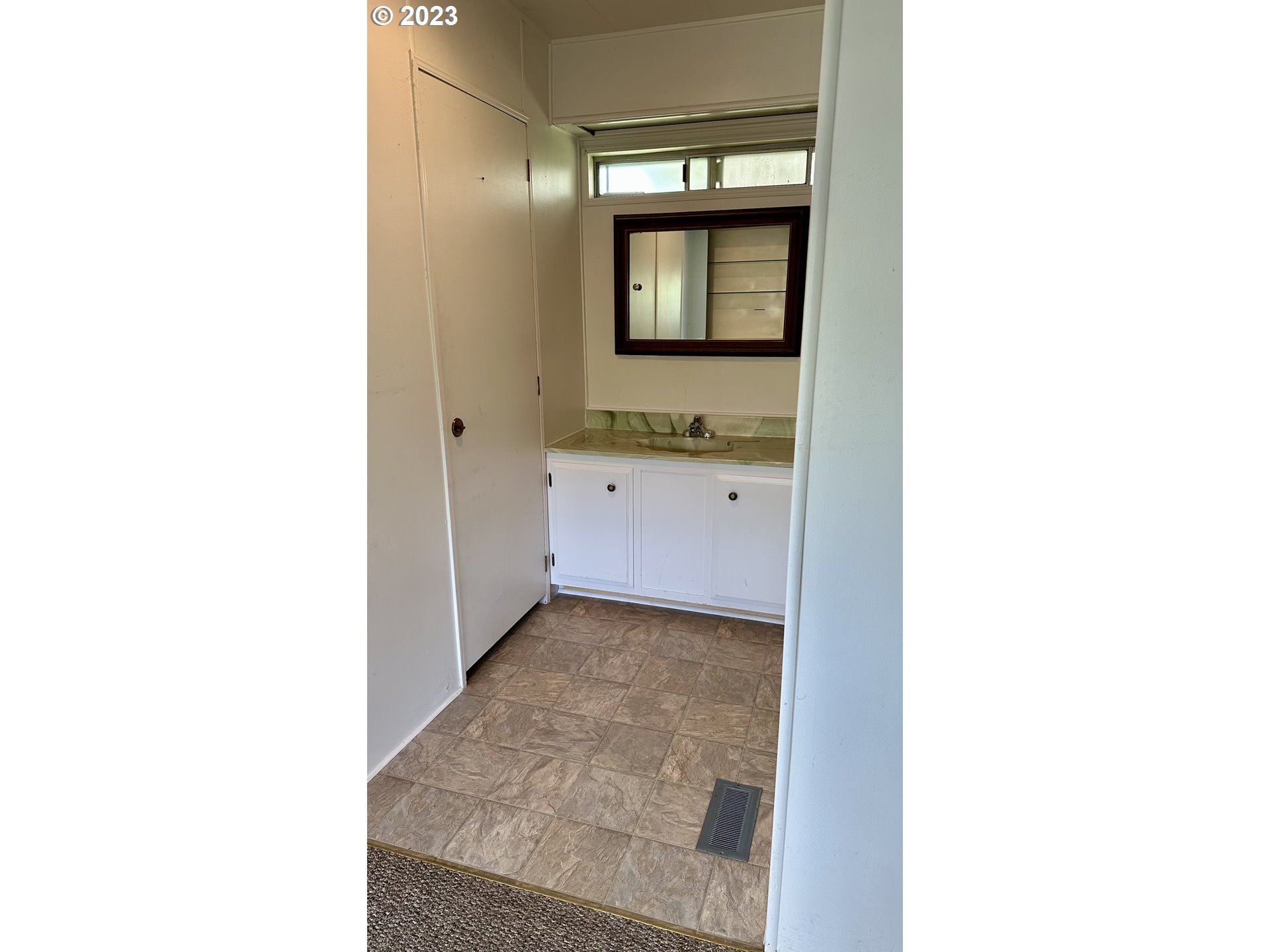 1695 Harbor Drive Springfield, OR 97477 - Photo 16 of 26 a hallway with a sink and a mirror
