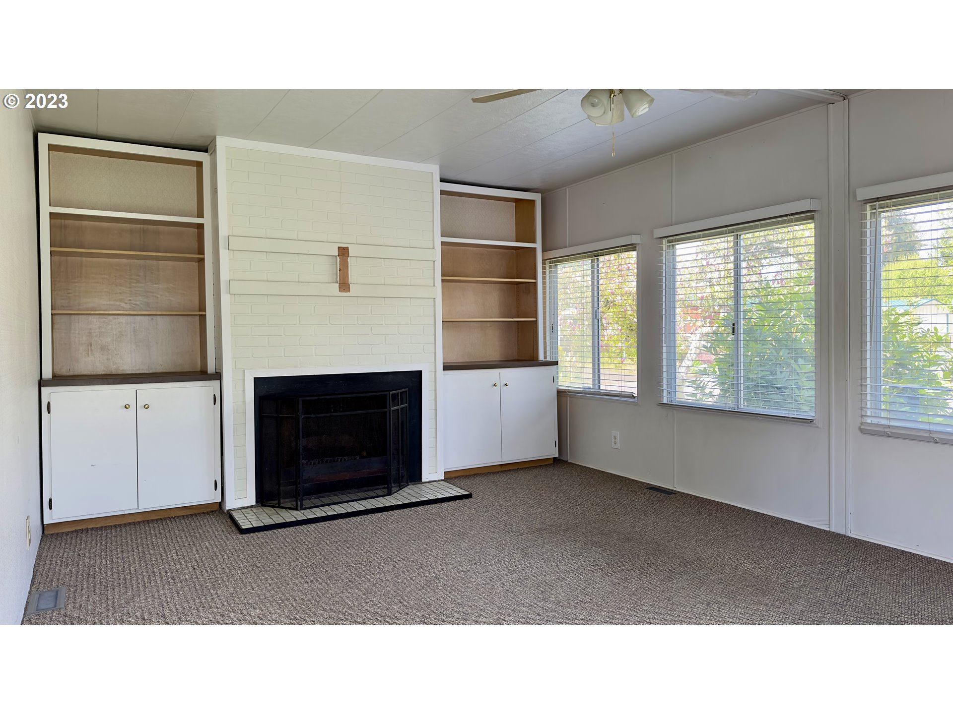 1695 Harbor Drive Springfield, OR 97477 - Photo 5 of 26 a open living room with furniture and a fireplace