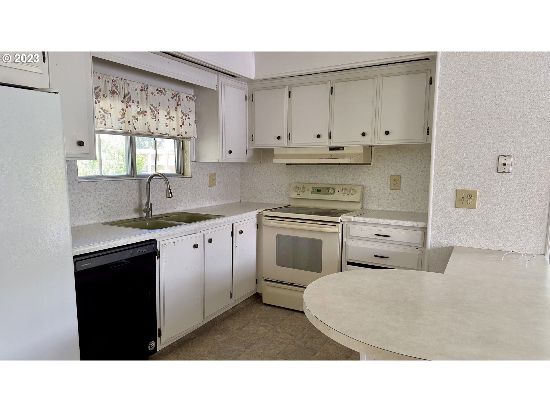 1695 Harbor Drive Springfield, OR 97477 - Photo 10 of 26 a kitchen with a sink a stove a refrigerator a window and cabinets