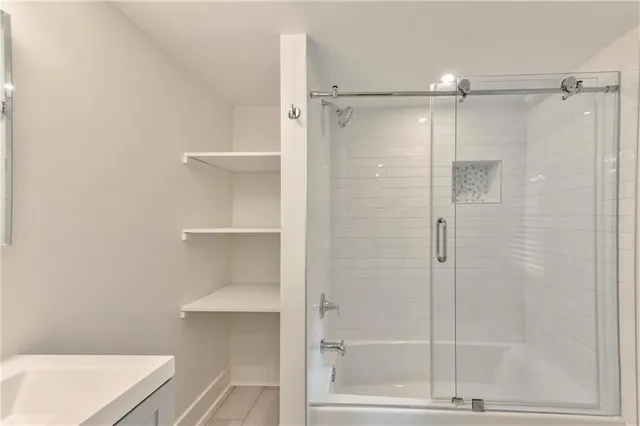 a bathroom with a shower and a sink