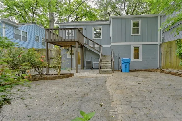 a view of a house with a yard and large tree