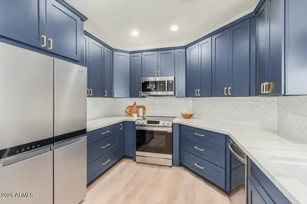 a kitchen with wooden cabinets and stainless steel appliances