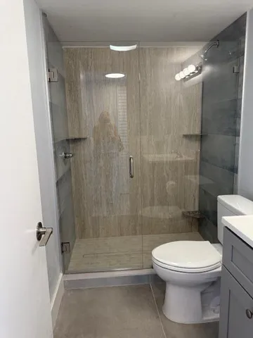 a bathroom with a toilet and shower