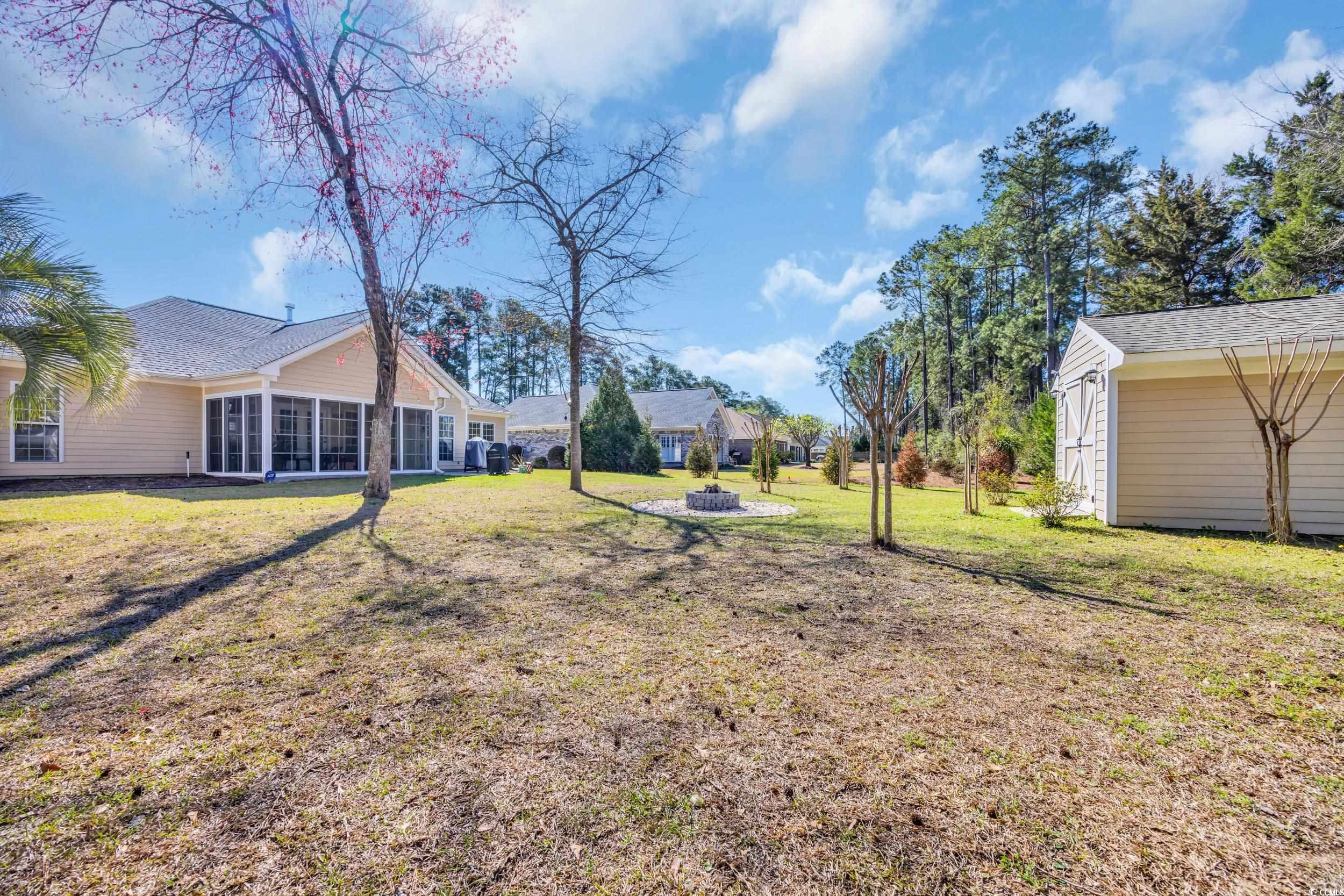 4208 Edgefield Road Little River, SC 29566 - Photo 26 of 33 View of yard featuring an outbuilding, a fire pit,