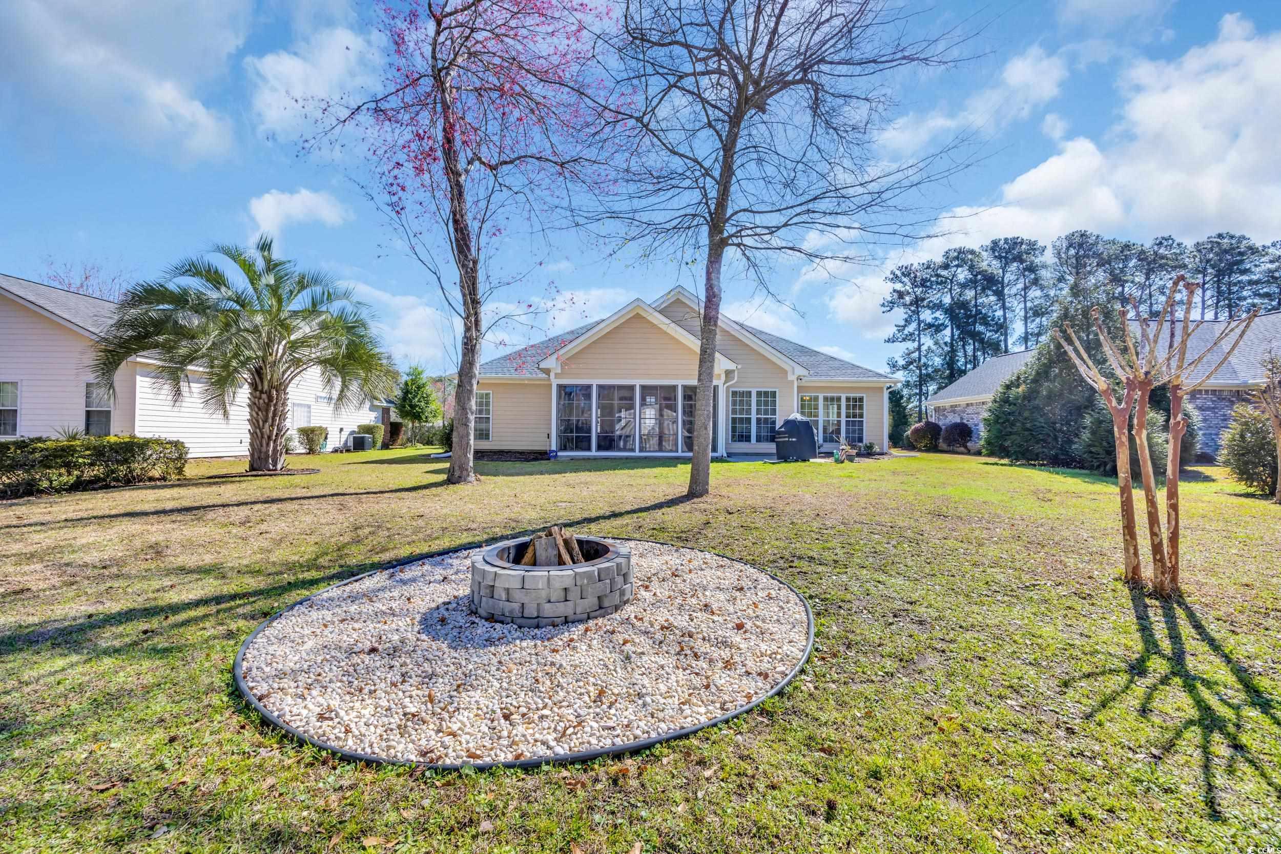 4208 Edgefield Road Little River, SC 29566 - Photo 28 of 33 Back of property featuring an outdoor fire pit, a