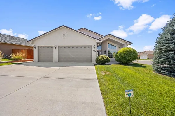 a front view of a house with a yard and garage