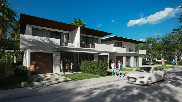 a view of a white house with a large windows and a yard