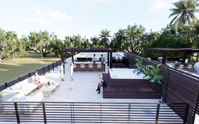a view of a patio with couches table and chairs and potted plants with wooden floor and fence