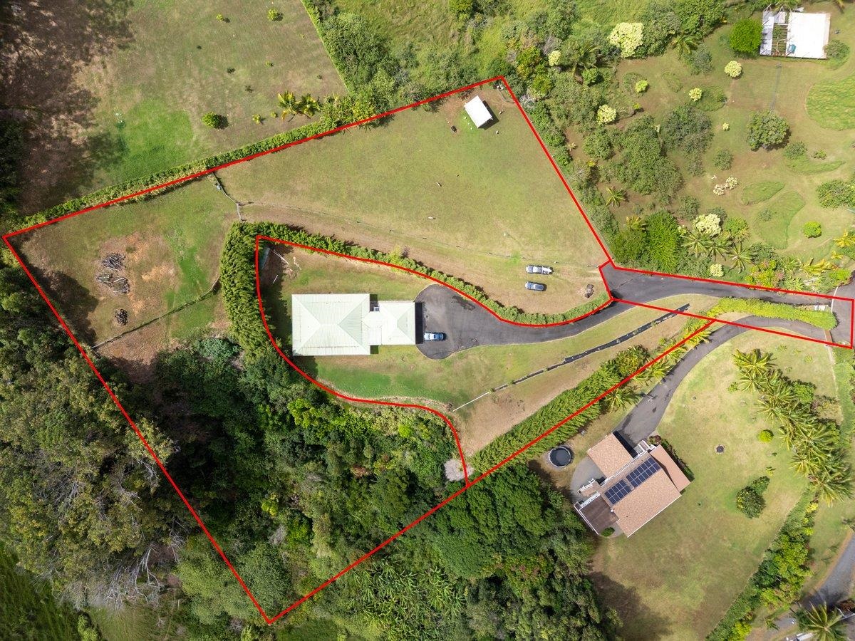 57 Awalau Road, Unit A Haiku, HI 96708 - Photo 4 of 22 an aerial view of a house with a yard and trees