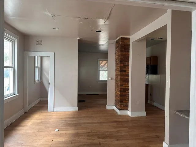 a view of a hallway with wooden floor and stairs