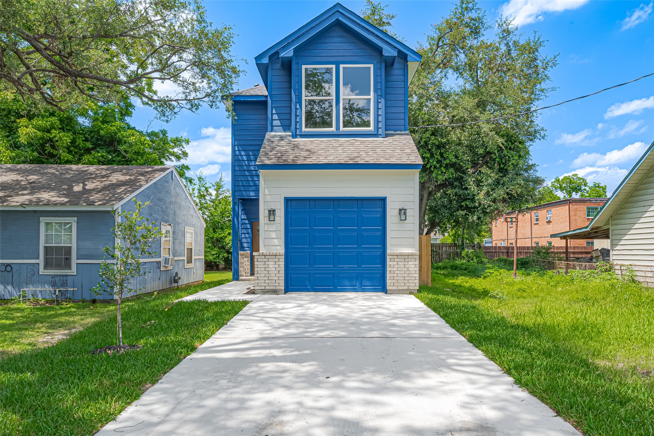 Perfect entryway surrounded by a neatly maintained lawn and fenced backyard.