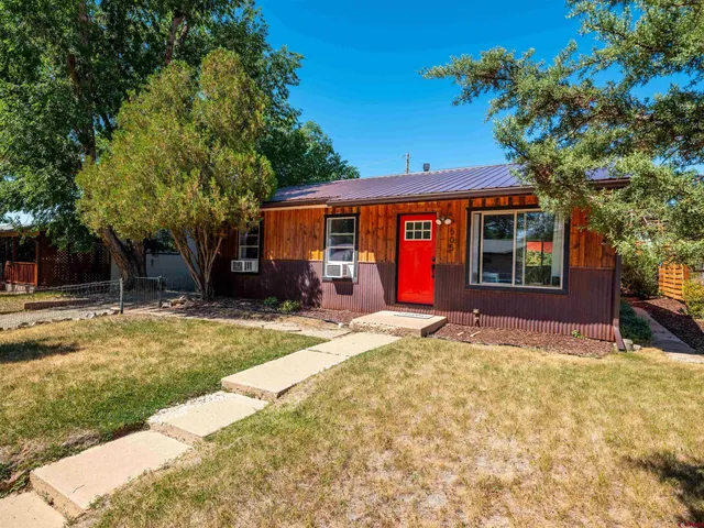 a view of a house with backyard porch and sitting area