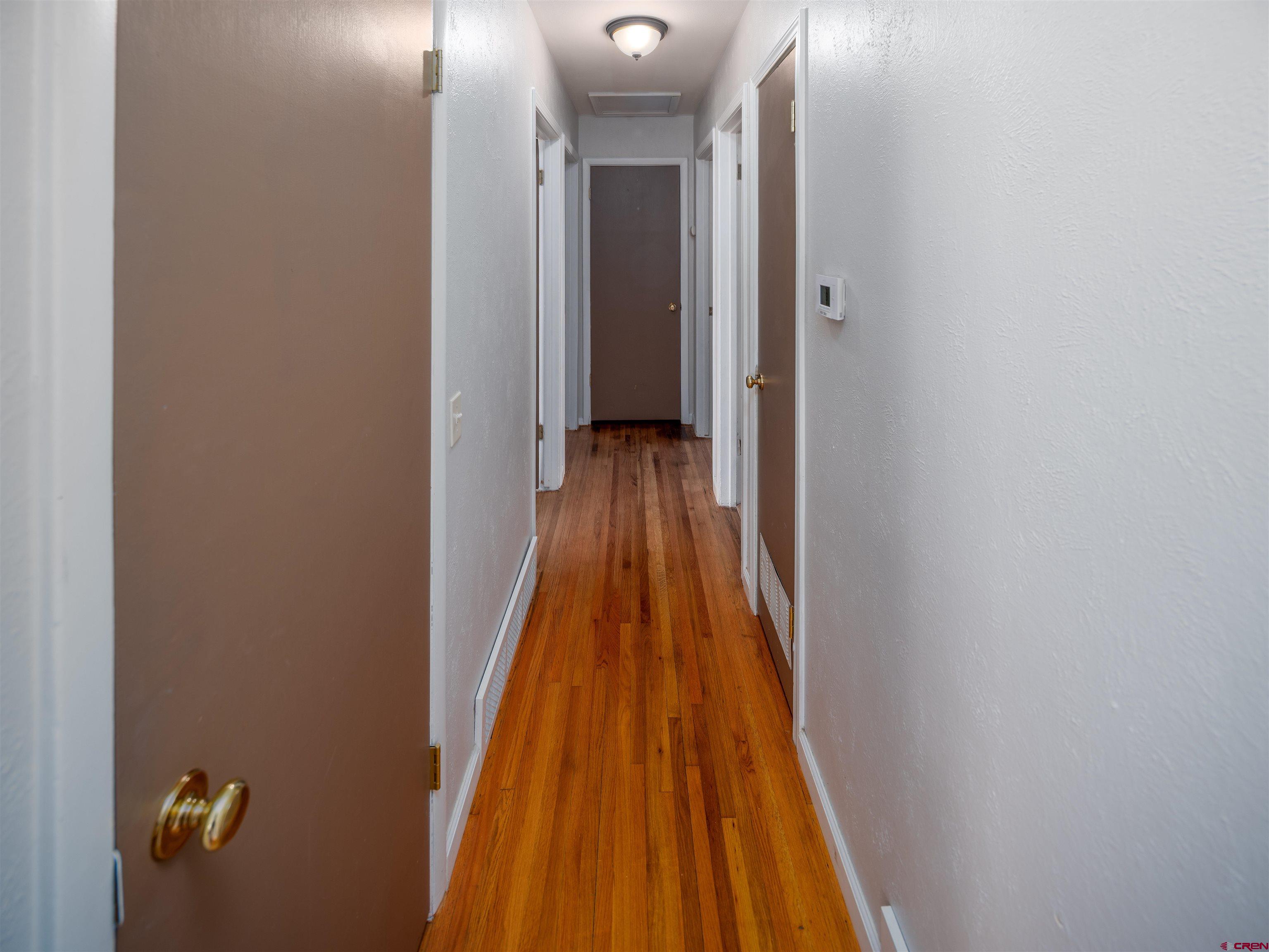 505 South Valley Road Cortez, CO 81321 - Photo 11 of 27 a view of a hallway with wooden floor and a bathroom