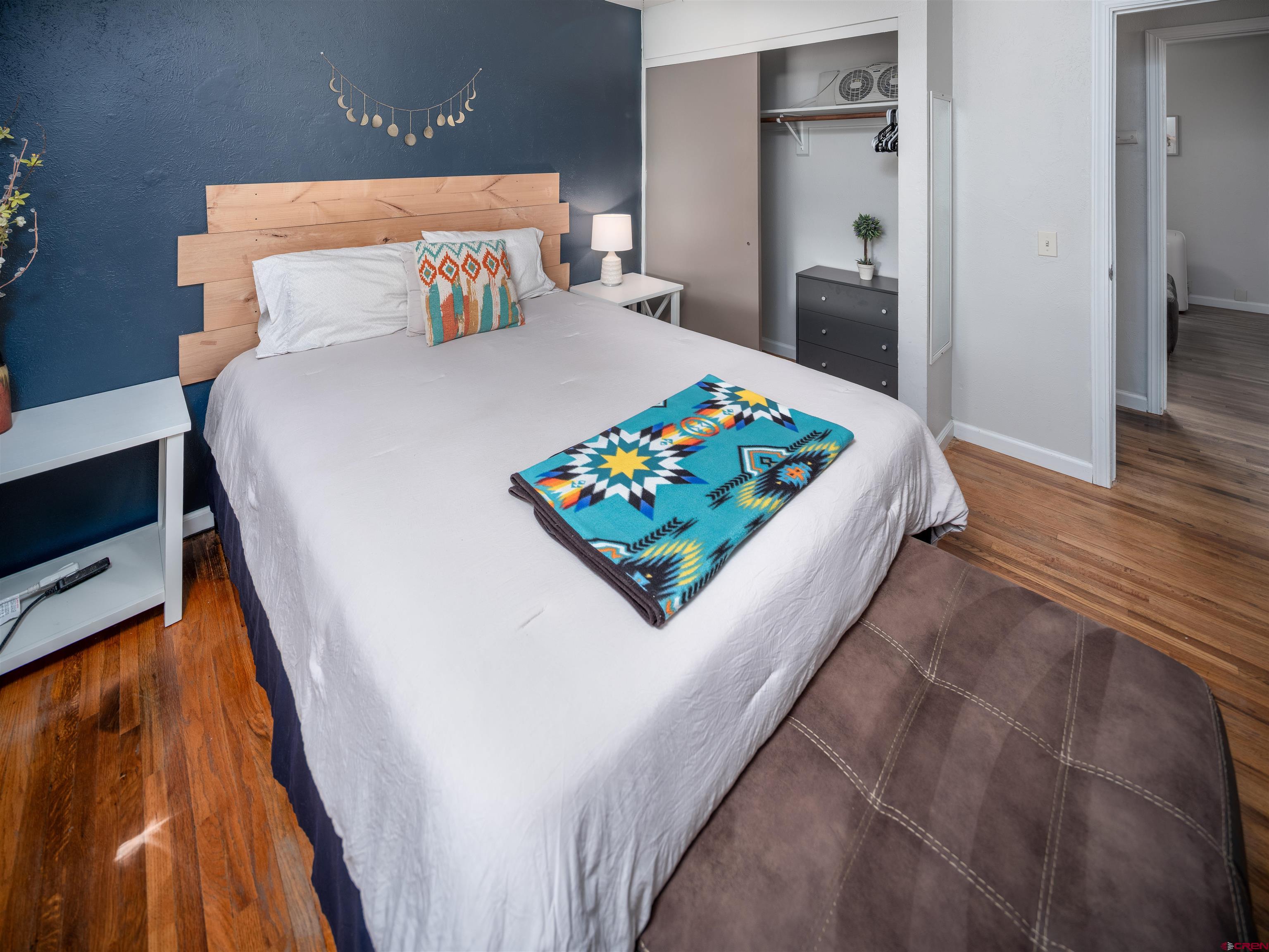 505 South Valley Road Cortez, CO 81321 - Photo 14 of 27 a bed sitting in a bedroom next to a window with a hallway