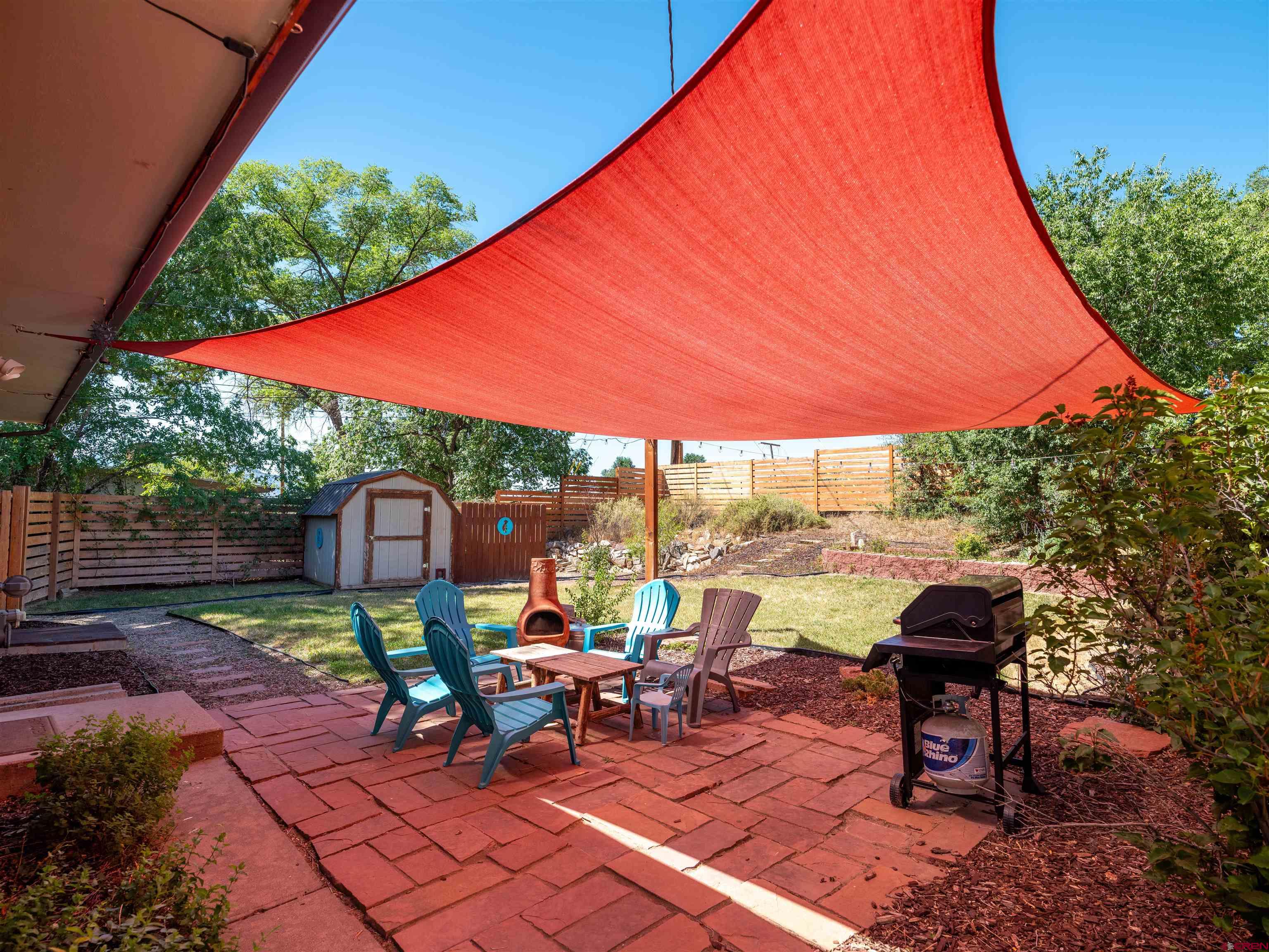 505 South Valley Road Cortez, CO 81321 - Photo 18 of 27 a view of a patio with table and chairs under an umbrella